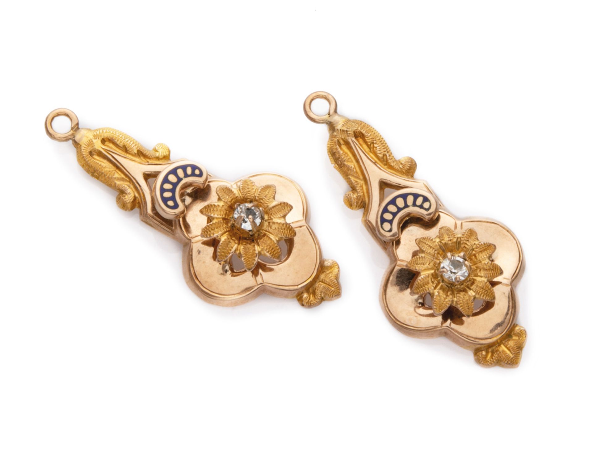 TWO FANTASY PENDANTS in yellow gold 18 kts., of mixtilineal body with central flower. Measures cm.