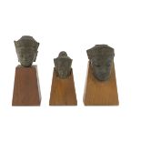 THREE HEADS IN COATED STONE, THAILAND 20TH CENTURY