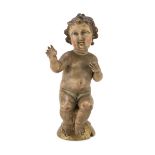 SCULPTURE OF THE CHILD IN WOOD, 18TH CENTURY in polychromy, with glass eyes. Measures cm. 22 x 11