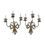 A PAIR OF APPLIQUES IN GILDED METAL, 20TH CENTURY with ramage arms to and petal sconces. Measures