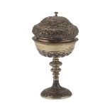 PYX IN SILVER, ITALY 19TH CENTURY entirely embossed with vegetal motifs and lilies. Fluted basin.