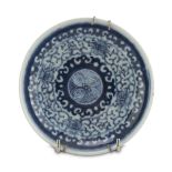 SAUCER IN WHITE AND BLUE PORCELAIN, CHINA 19TH CENTURY decorated with vegetal interlacements and