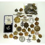 A group of thirty military badges, cap badges and brooches,