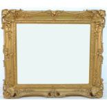 A Victorian style gilt composition frame, with rectangular mirror plate, 101 by 90 by 9cm.
