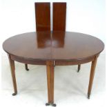 A Georgian mahogany D end dining table, with two additional leaves,