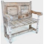 A Victorian and later pine settle, with two panel back, solid seat and turned supports,