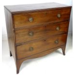 A Regency mahogany chest of three drawers, with cock beading and brass ring handles,