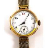 A vintage 9ct gold cased wristwatch with white enamel dial with subsidiary seconds dial,