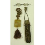 A moulded glass inro, in the style of Chinese jade, with attached string and tassels, 6 by 5cm,