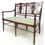 A Victorian mahogany two seater open armed settee,