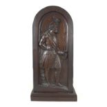 An oak carved panel, 18th / 19th century, depicting a Scottish chieftain with feathered hat,