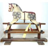 A mid 20th century child's rocking horse, carved wood and painted dappled grey, with red saddle,