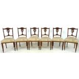 A set of six Edwardian mahogany dining chairs, with carved frames,