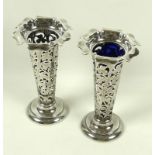 A pair of silver posy vases, each decorated with scrolling design of shamrocks,