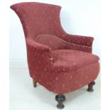 A late Victorian armchair with shaped back, upholstered in red and cream diamond patterned fabric,