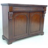 A Victorian mahogany chiffonier, two frieze drawers, carved corbels flanking two doors,