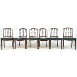 A set of six Sheraton style mahogany dining chairs, carved splats to an arched top rail,