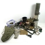 A collection of military issue items including canvas kit and equipment bags,