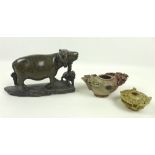 A group of three Chinese soapstone carvings, 20th century, one modelled as a buffalo with young,