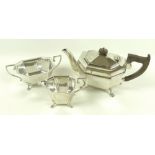 An Art Deco silver three piece tea service, each of faceted form with four paw feet,