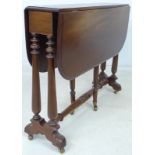 A Victorian mahogany drop leaf table, with turned supports and brass castors, 84 by 21 by 67.
