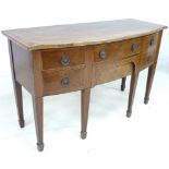 An Edwardian mahogany bow fronted side board with four drawers, raised on square section legs,