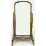 A mahogany Victorian style cheval mirror, with full length arched rectangular plate,