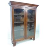 An Edwardian mahogany display cabinet, cornice over two glazed doors, three adjustable shelves,