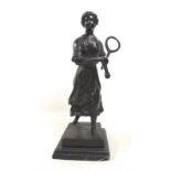 A modern bronze sculpture, modelled as a young Edwardian lady playing tennis,