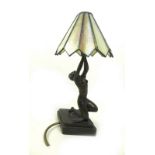 An Art Deco style figural lamp, formed as a bronzed woman semi nude and holding up the light,