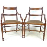 A pair of Victorian mahogany open armchairs, with brass applied plate to underside of seat,