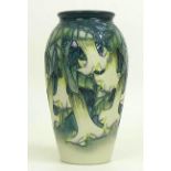 A limited edition Moorcroft pottery vase, Angels trumpet pattern, depicting cream flowers on green