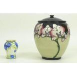 A modern Moorcroft vase and cover, the body depicting cream and pink orchids on cream and black