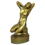 An Art Deco Zsolnay Pecs figurine, modelled as a female nude in kneeling pose with her hand