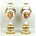 A pair of large modern Royal Worcester pedestal vases, foliate clasped twin handles, decorated in