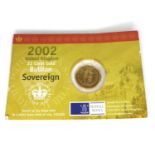 An Elizabeth II gold shield back sovereign, 2002, in original card packaging.