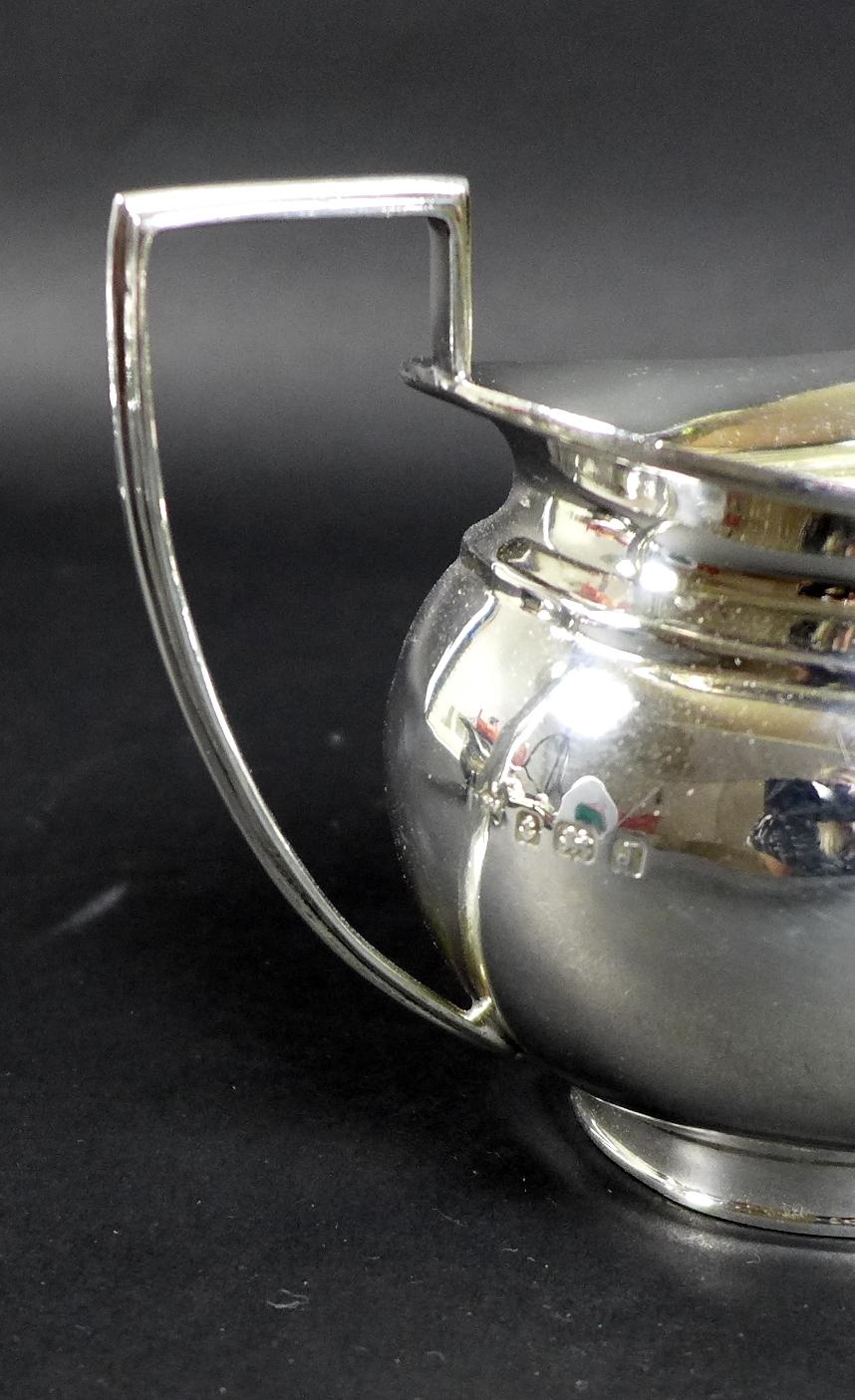 A George V silver three piece tea service, London shape, comprising teapot, twin handled sugar bowl, - Image 10 of 11