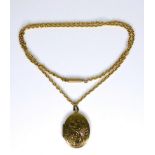 A 15ct gold chain with 9ct gold foliate engraved oval locket, locket 5.6g, chain 10.4g.