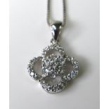 An 18ct white gold and diamond necklace, the diamond set flowerhead pendant totalling