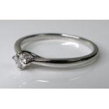 A platinum and diamond solitaire ring, the central brilliant cut stone of approximately 0.13ct, size