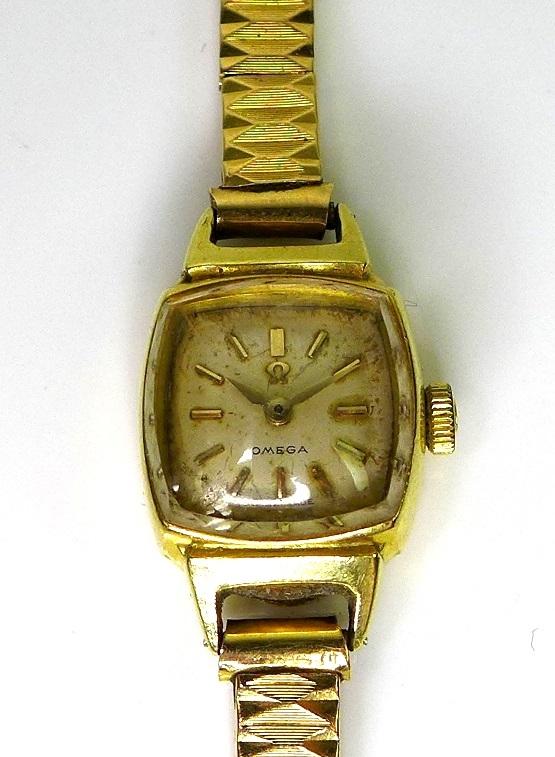 An 18ct gold Omega gold cocktail watch with 15ct gold strap, and a 9ct gold miniature schnauzer