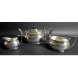 A George V silver three piece tea service, London shape, comprising teapot, twin handled sugar bowl,