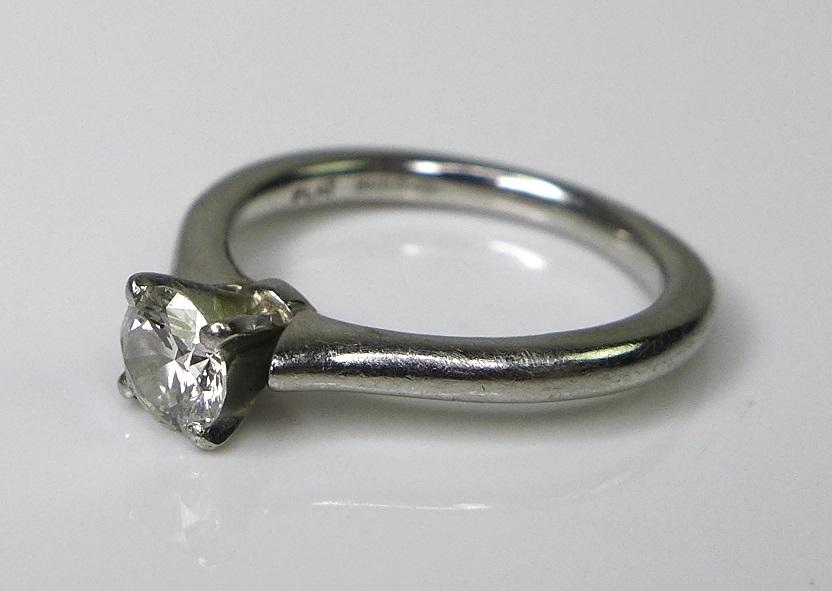 A platinum and diamond solitaire ring, the brilliant cut stone approximately 0.2ct, 4.5 by 4.5mm,