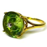 A 10K gold ring set with green quartz torus, set to centre with diamond, size N, limited edition 1