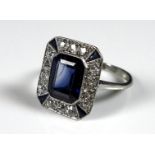 An Art Deco style synthetic sapphire and diamond dress ring, circa 1980, with central emerald cut