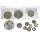 A group of silver coins comprising an 1886 silver Morgan dollar, an 1896 silver Morgan dollar, a