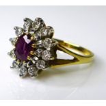 A 9ct gold ring set with diamonds encircling central ruby, approx 0.5ct total diamond weight, size