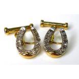A pair of 14ct gold and diamond cufflinks formed as horseshoes, each set with seven diamonds, with