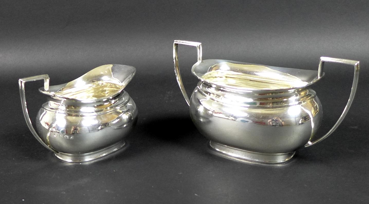 A George V silver three piece tea service, London shape, comprising teapot, twin handled sugar bowl, - Image 9 of 11