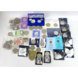 A collection of coins including a silver £1 proof coin, various £5 coins and various silver